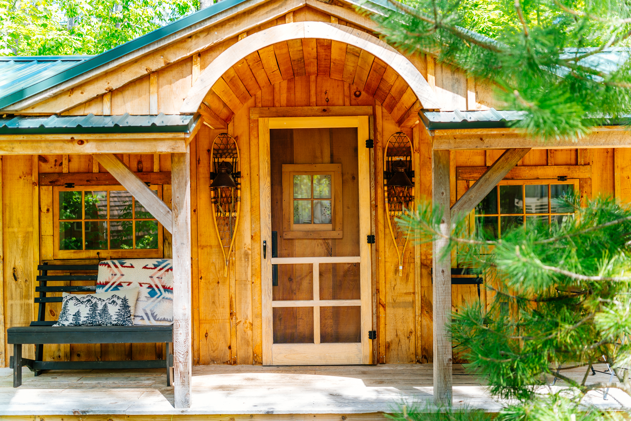 Handcrafted Cabin Entryway with Arched Cedar Porch